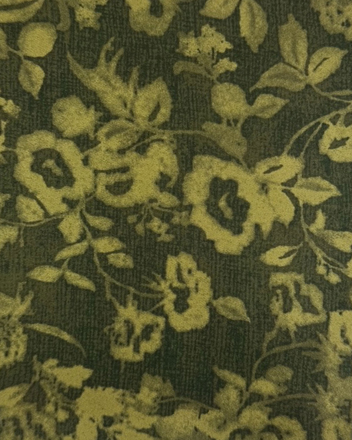 Floral patterned fabric with green leaves and flowers on a dark background