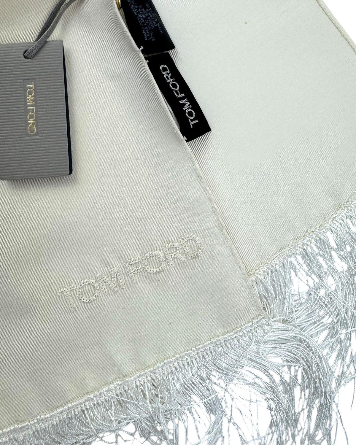 Tom Ford scarf with fringe detail on a light background